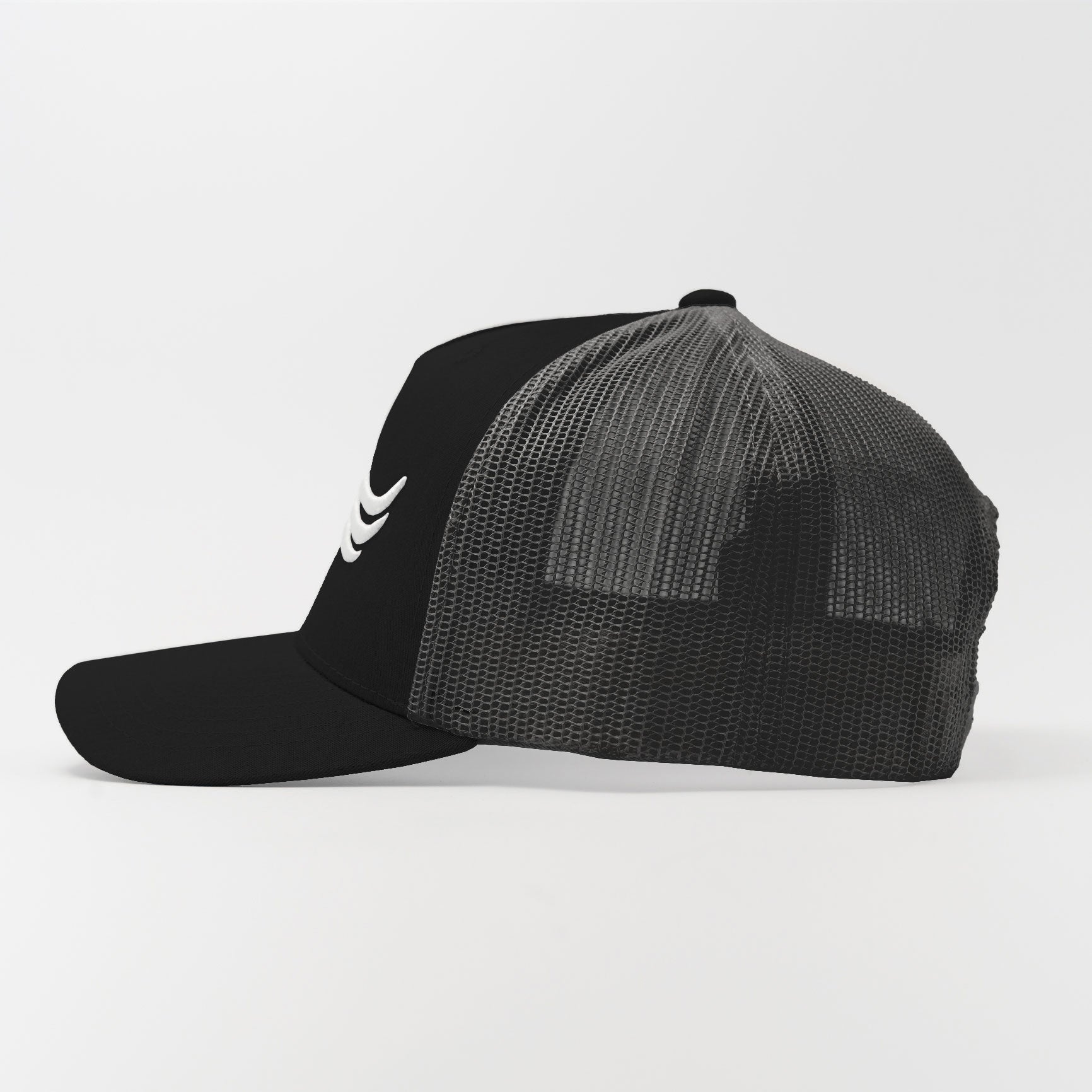 Trucker Hat – Core Black | Side view showing solid structure and black mesh ventilation
